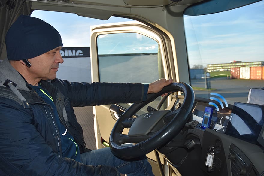 picture of a man sitting in a truck looking at his pager
