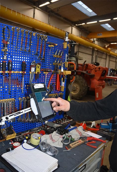 picture of a workshop where a person presses on a terminal