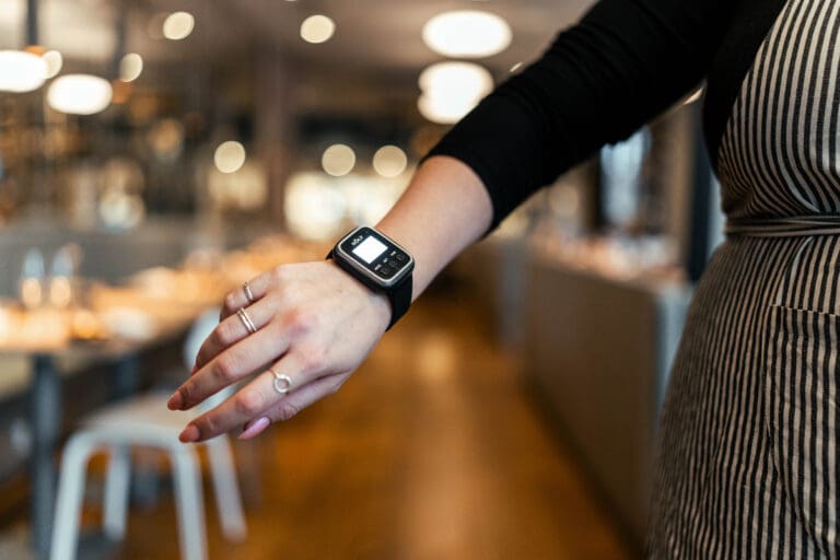 picture of a solt unit pager watch on the wrist of a waiter