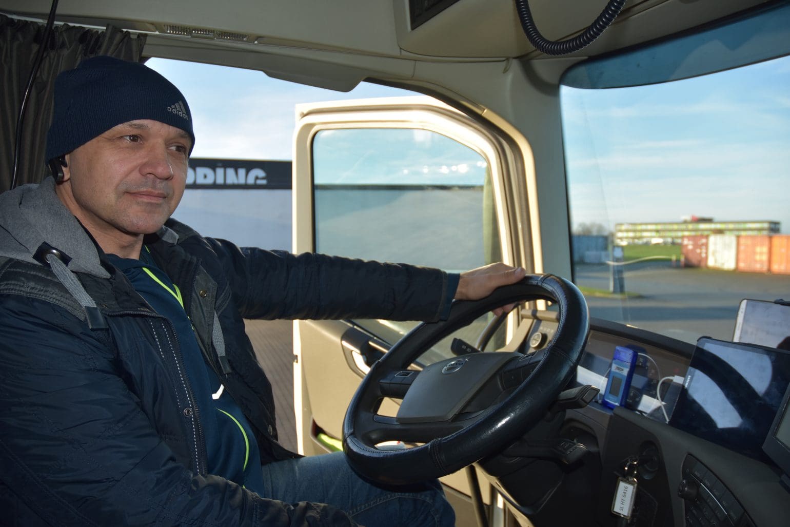 truck driver sitting in a truck with a pager system