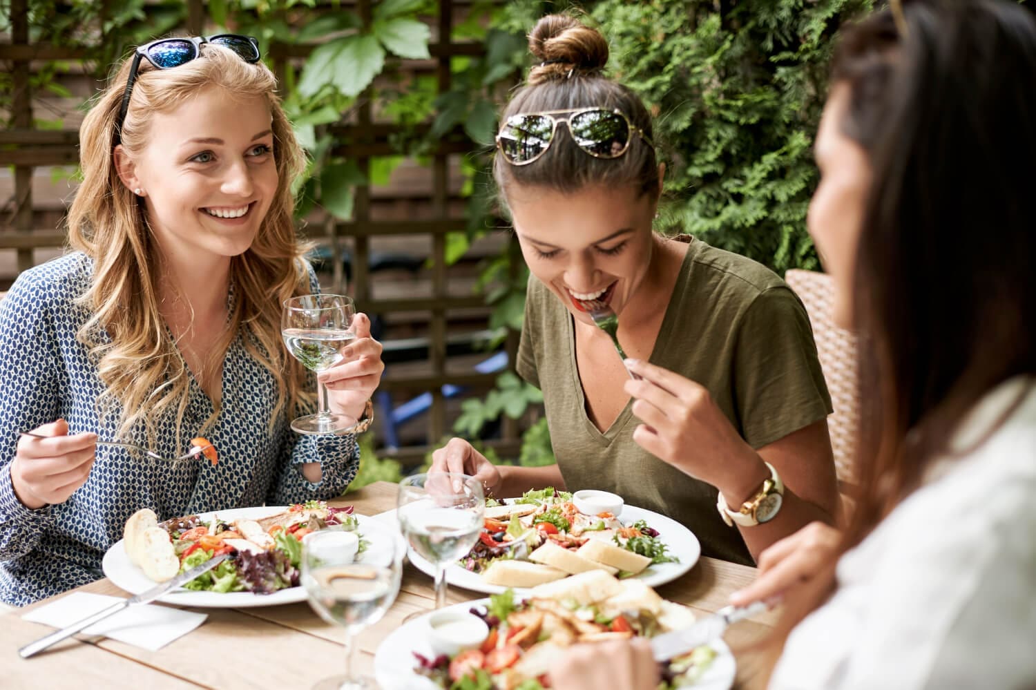 picture of three women sitting, eating lunch