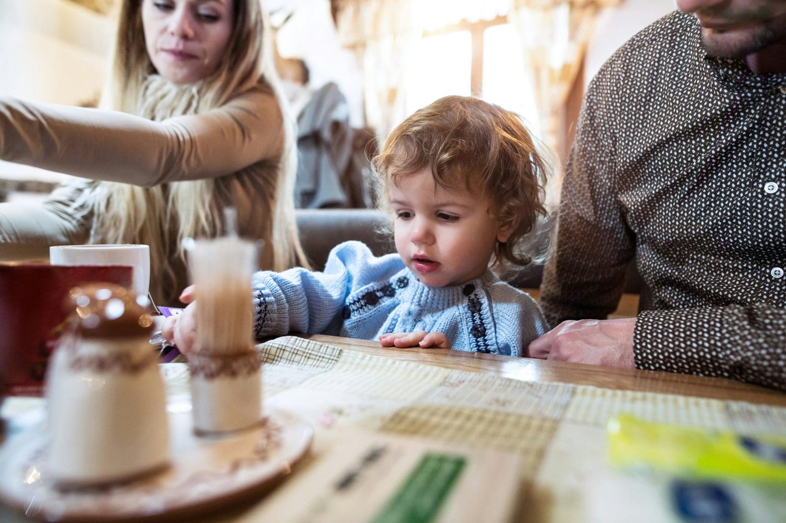 picture of parents with their child picking at the down on the table