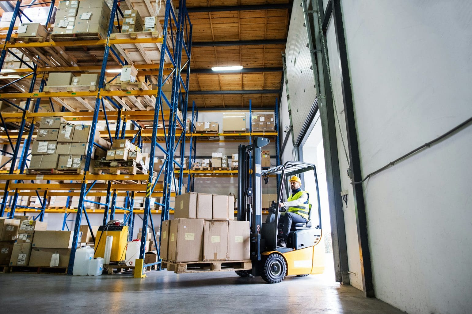 picture of a forklift truck carrying packages into the warehouse