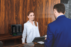 picture of receptionist welcoming a guest