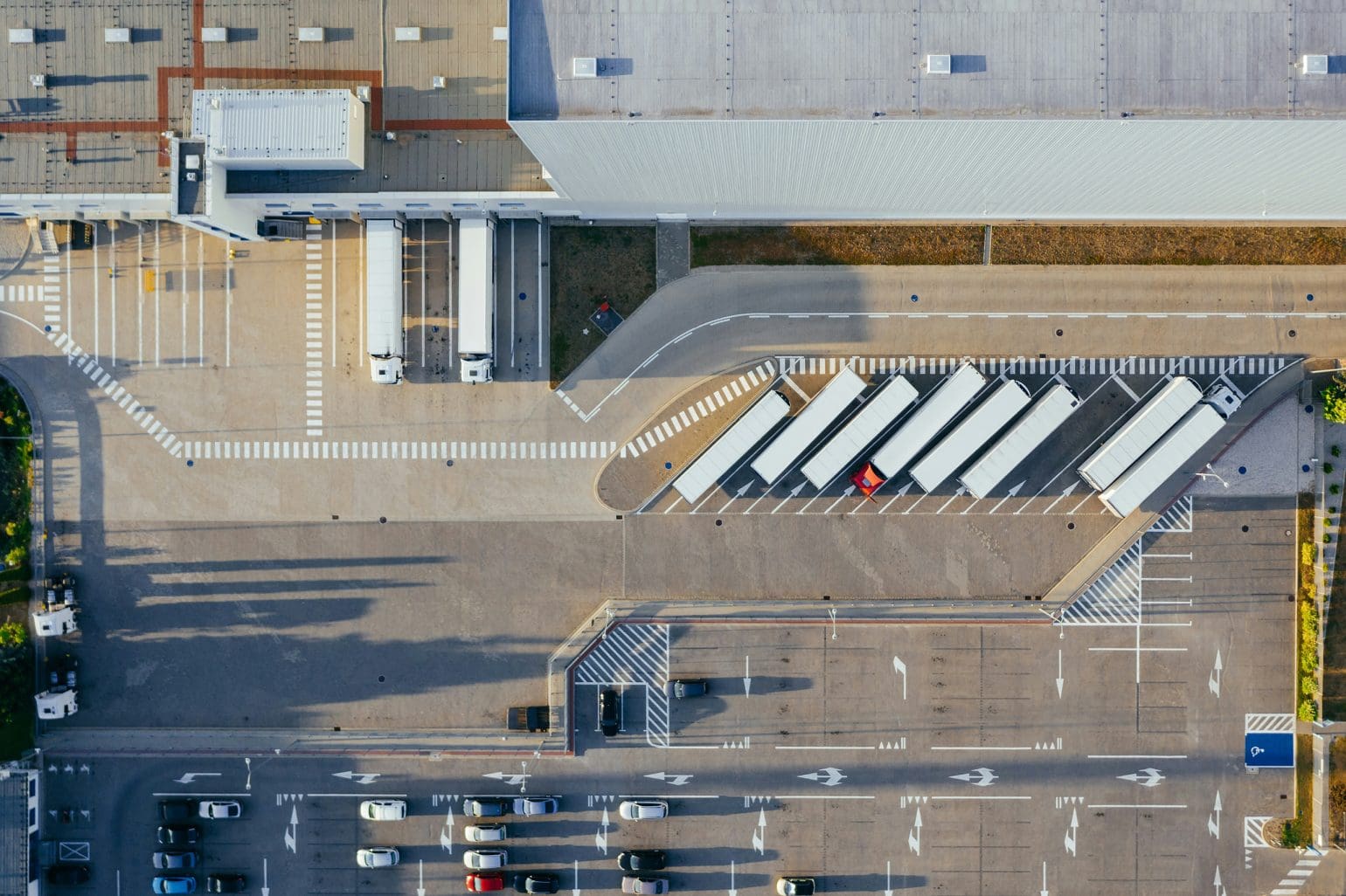 picture of a parking lot with cars and trucks taken from above