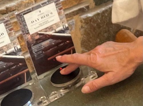 picture of a hand presses a pager for a staff call in a wellness center