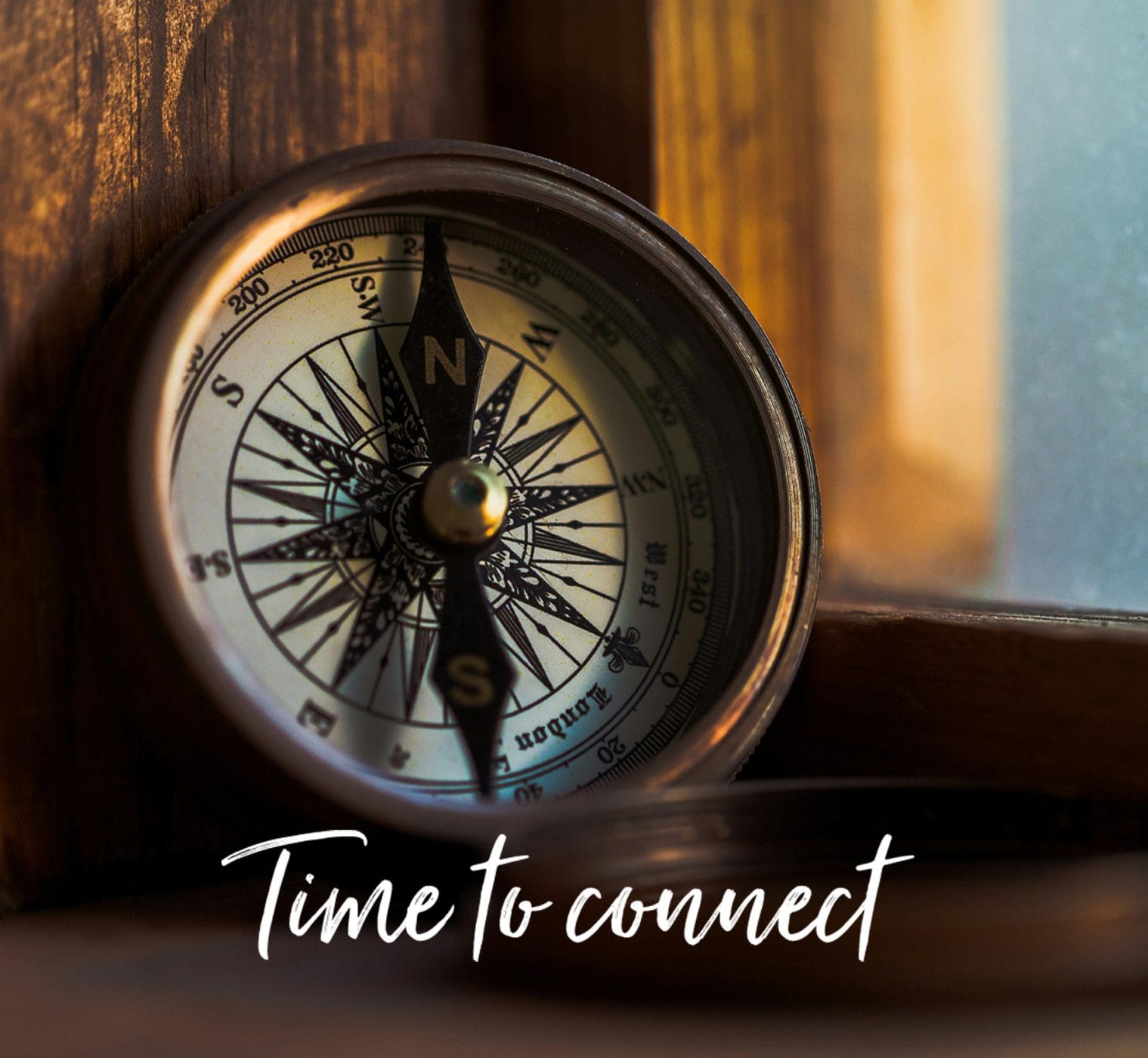 picture of a compass with the words Time to connect below the compass