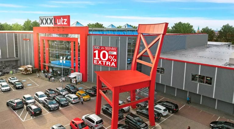 picture of giant red chair in the middle of XXXLutz parking lot