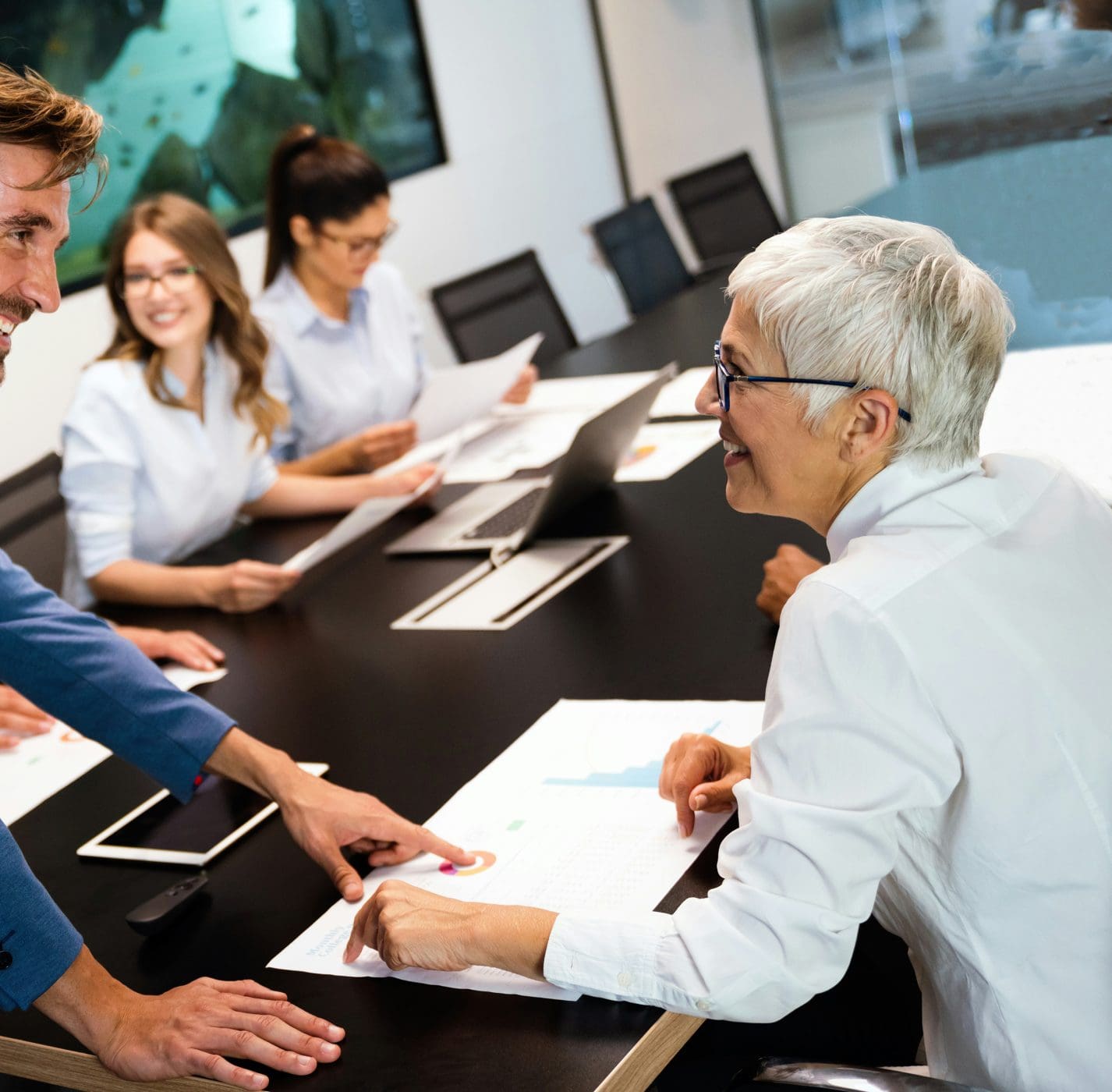 smiling people sitting in a meeting and discussing