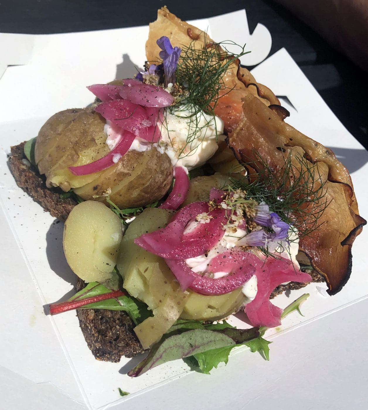 Picture of rye bread meal with potatoes, salad and smoked bacon.
