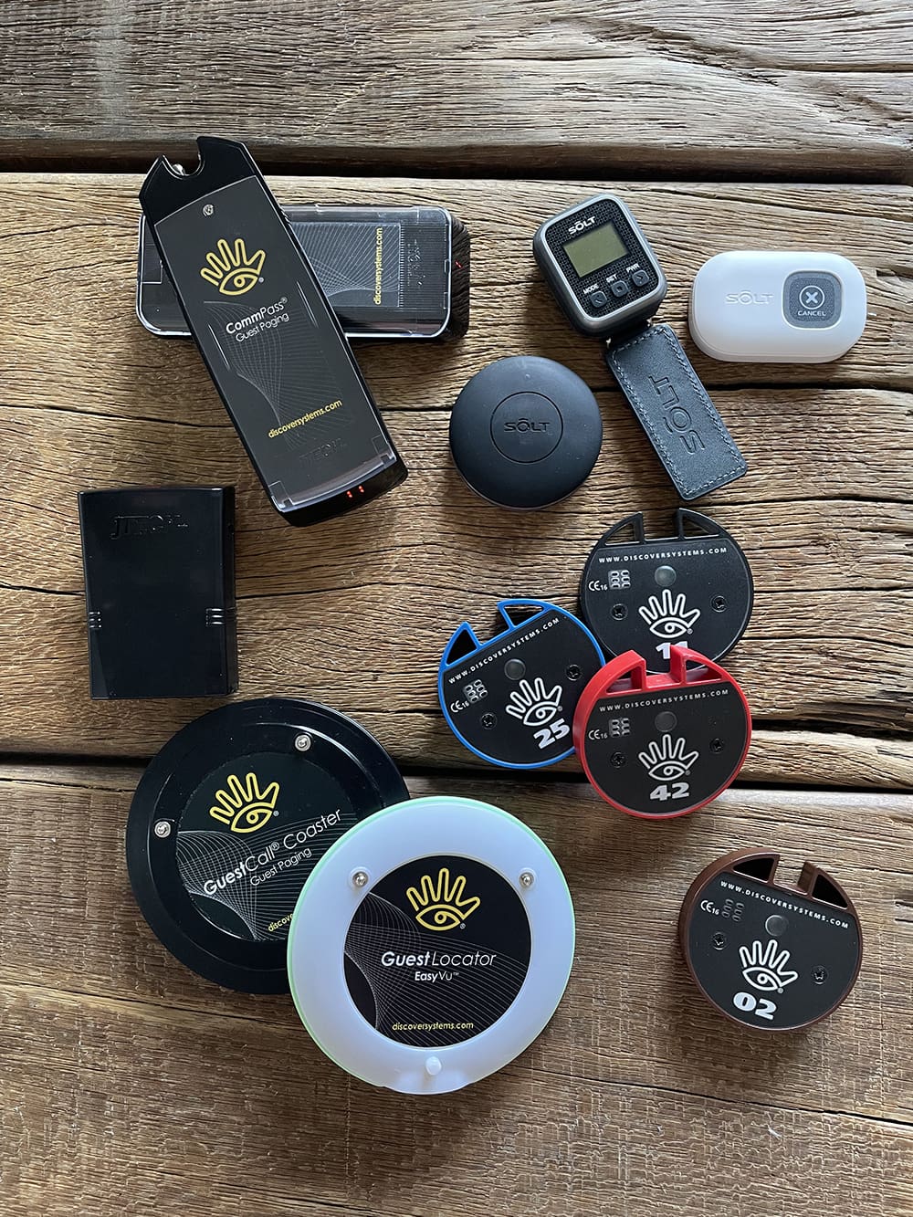 picture of various pager systems and pucks lying on a table