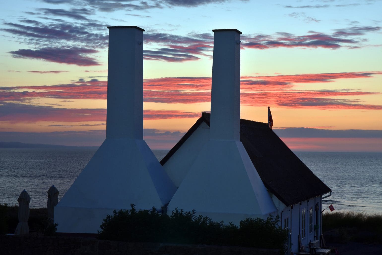 picture of a smokehouse by the sea