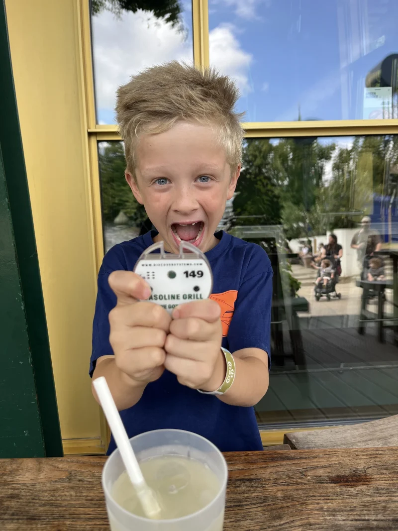 Happy boy with a pager, waiting for his pommes maybee