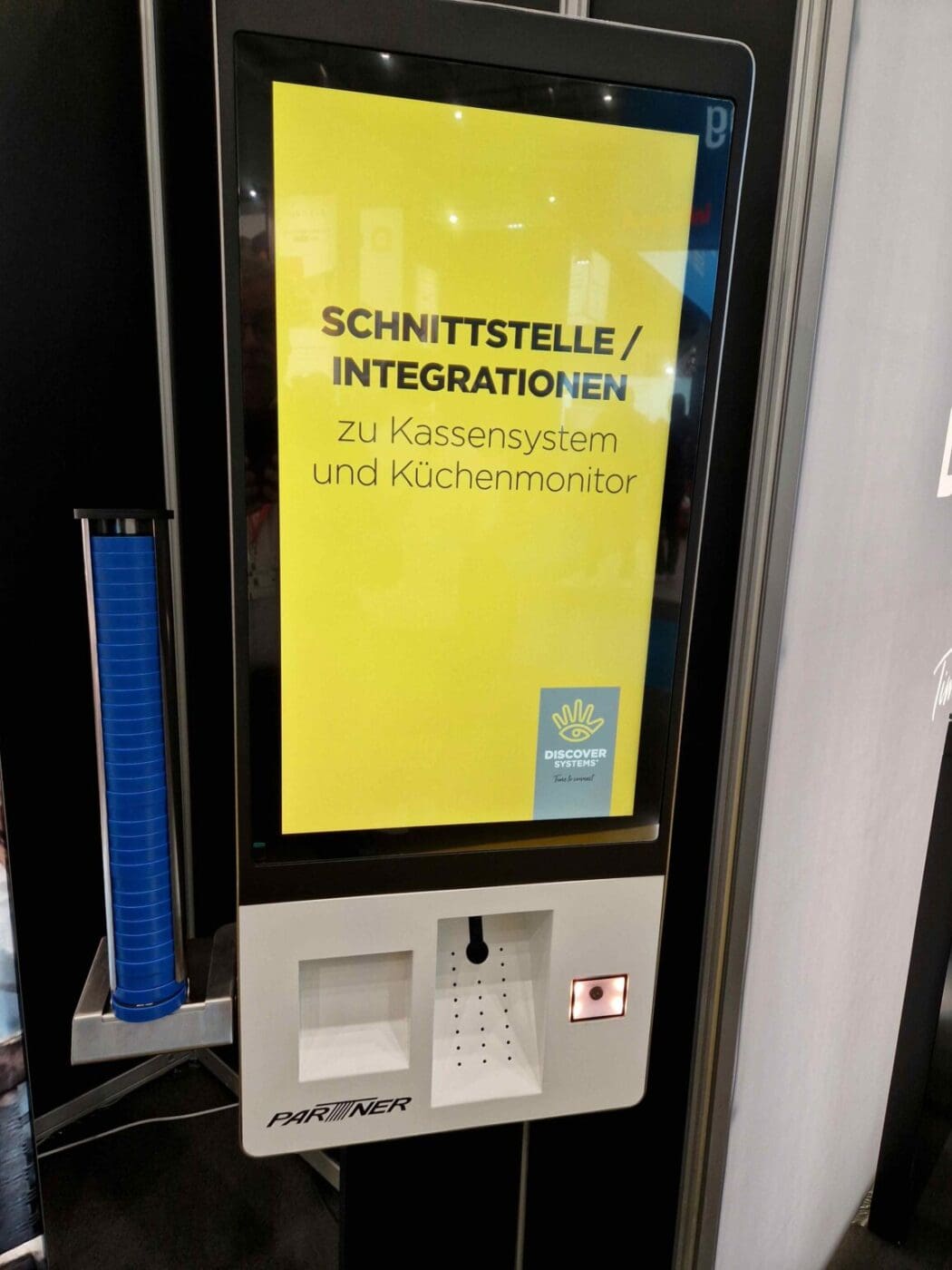 Self service kiosk with integrated wireless pager holder for order pickup