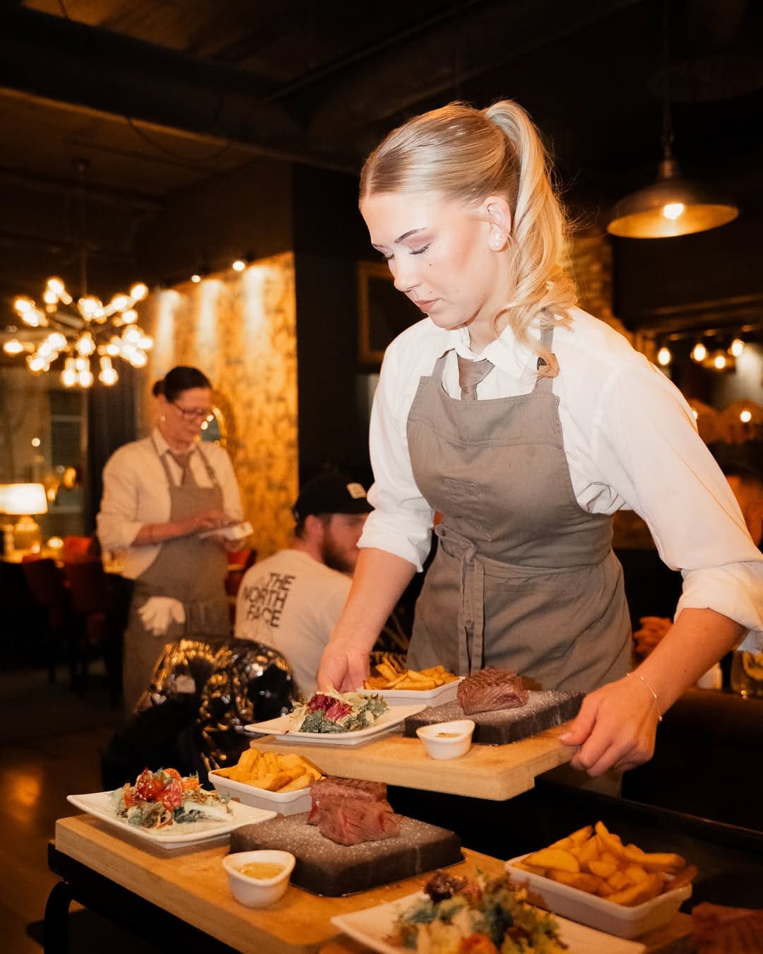 Restaurant staff serving guests at Blackstone Gävle