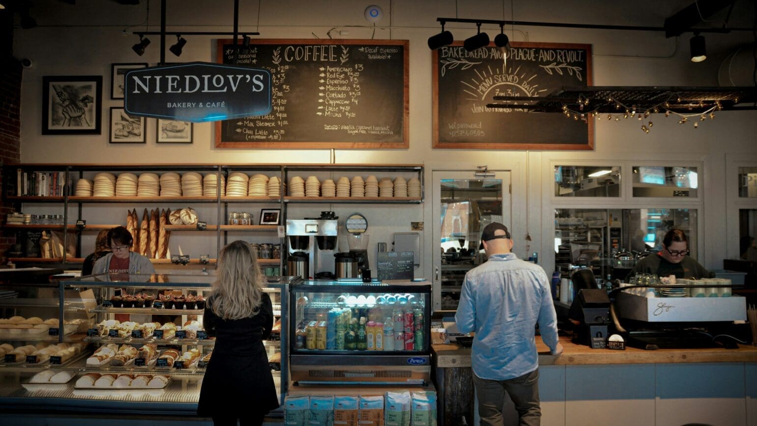 busy bakery with customers waiting in line