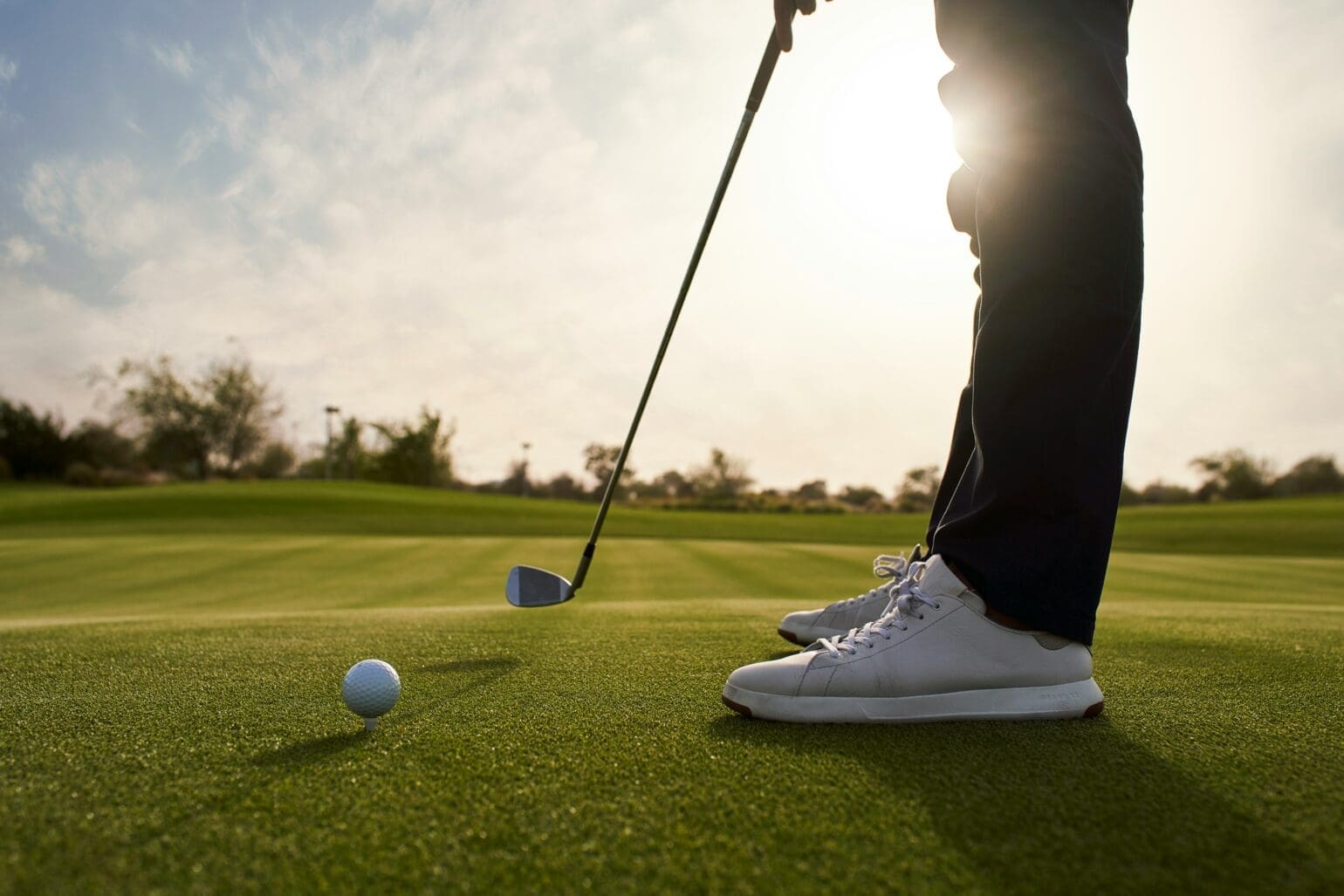 Golf player preparing a shot on the green at a golf course